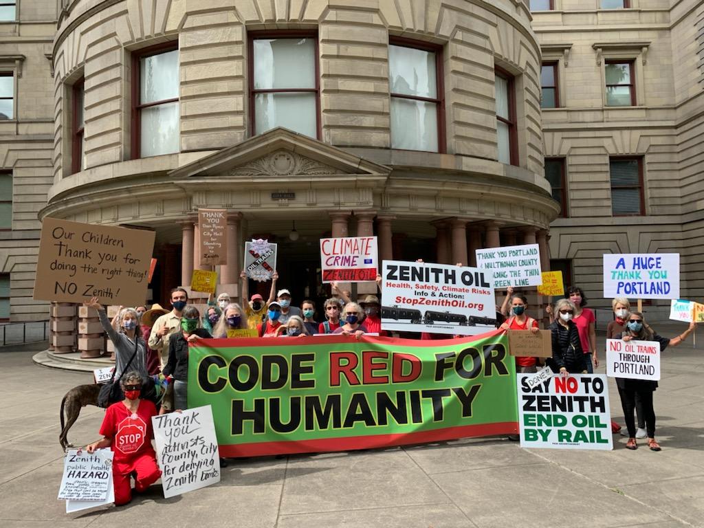 Stop Zenith activists in front of Portland City Hall celebrating the denial of the LUCS. They have a banner that says "Code Red for Humanity"